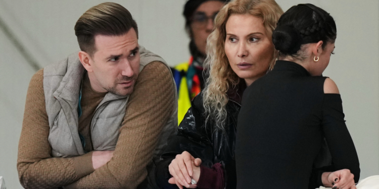 Adeliia Petrosian (right) speaks with coach Eteri Tutberidze (centeR) and choreographer Daniil Gleikhengauz, during a figure skating practice session at the 2026 Winter Olympics, in Milan, Italy, Monday, Feb. 16, 2026.
