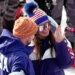 Breezy Johnson looks at the engagement ring she was given by Connor Watkins, at the finish area of an alpine ski, women's super-G race, at the 2026 Winter Olympics, in Cortina d'Ampezzo, Italy, Thursday, Feb. 12, 2026.