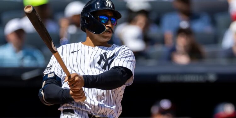 New York Yankees outfielder Trent Grisham (12) hits a solo home run.