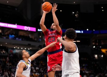 St. John's Red Storm guard-forward Bryce Hopkins (23) shoots over Marquette Golden Eagles forward Royce Parham (13).