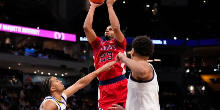 St. John's Red Storm guard-forward Bryce Hopkins (23) shoots over Marquette Golden Eagles forward Royce Parham (13).