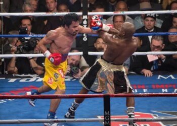 Manny Pacquiao punching Floyd Mayweather Jr. during their Welterweight Championship fight.