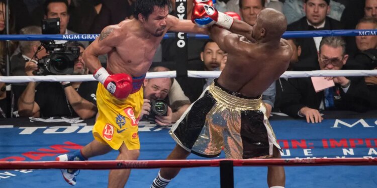 Manny Pacquiao punching Floyd Mayweather Jr. during their Welterweight Championship fight.