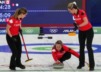 Canada's arah Wilkes, Rachel Homan and Emma Miskew in action during the women's curling round robin session against Switzerland at the 2026 Winter Olympics, in Cortina d'Ampezzo, Italy, Saturday, Feb. 14, 2026.