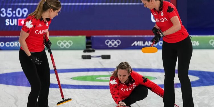 Canada's arah Wilkes, Rachel Homan and Emma Miskew in action during the women's curling round robin session against Switzerland at the 2026 Winter Olympics, in Cortina d'Ampezzo, Italy, Saturday, Feb. 14, 2026.