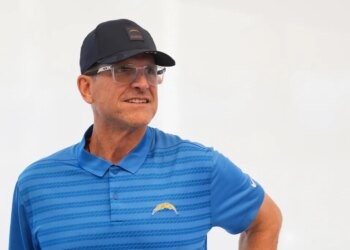 Los Angeles Chargers coach Jim Harbaugh looking to his right during a press conference.