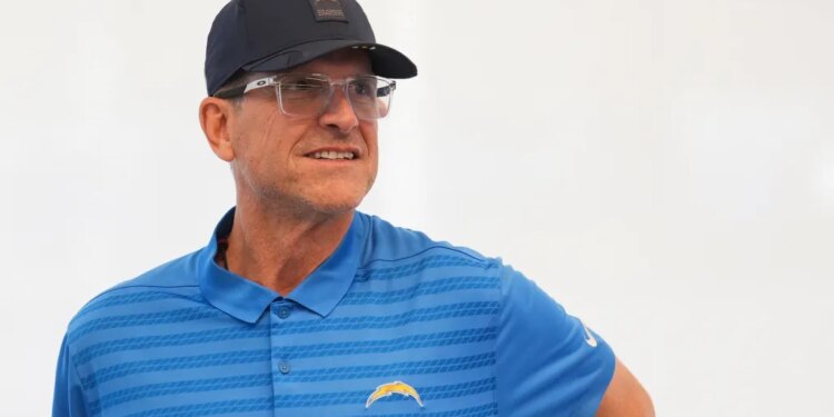 Los Angeles Chargers coach Jim Harbaugh looking to his right during a press conference.