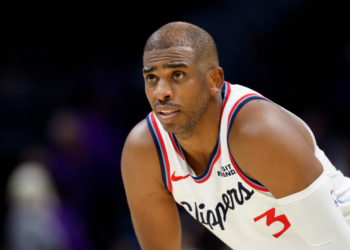 Chris Paul wearing a white Clippers jersey.