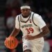 Reese Dixon-Waters dribbles a basketball in a San Diego State uniform.