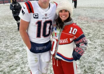 Patriots quarterback Drake Maye and his wife Ann Michael Maye  on the field after New England beat the Broncos in the AFC Championship game in Denver, Sunday, January 25, 2026.