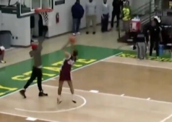 A fan tried to stop this layup attempt in a bizarre moment.