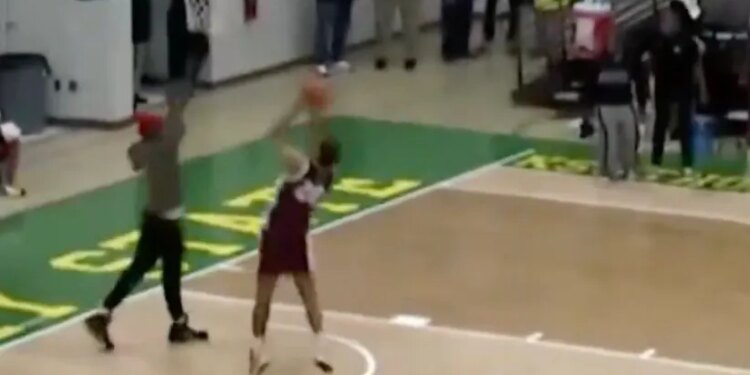 A fan tried to stop this layup attempt in a bizarre moment.