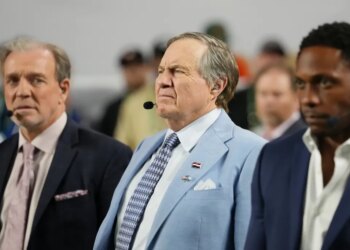 TV analyst Bill Belichick watches the game.