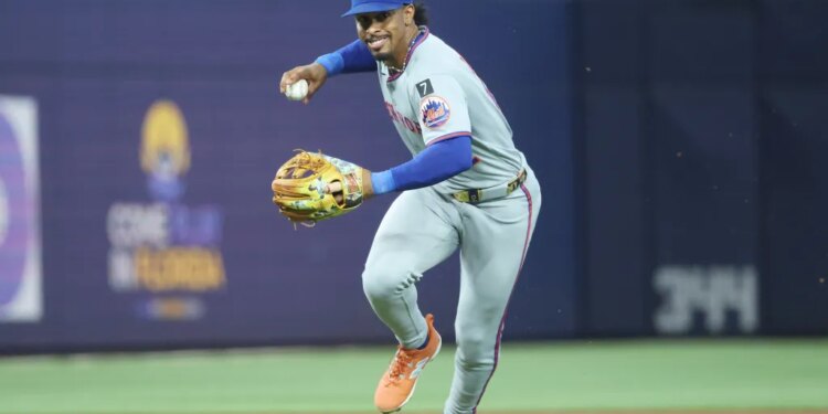 Francisco Lindor of the New York Mets throws out Otto Lopez of the Miami Marlins.
