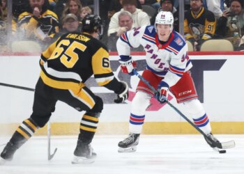 New York Rangers right wing Gabe Perreault (94) handles the puck against Pittsburgh Penguins defenseman Erik Karlsson (65) during the first period at PPG Paints Arena.