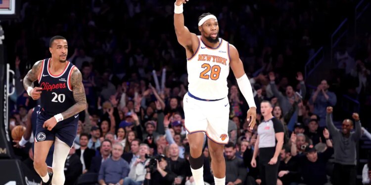 - New York Knicks forward Guerschon Yabusele #28 reacts after he hits a three-point shot over LA Clippers forward John Collins #20 during the fourth quarter.