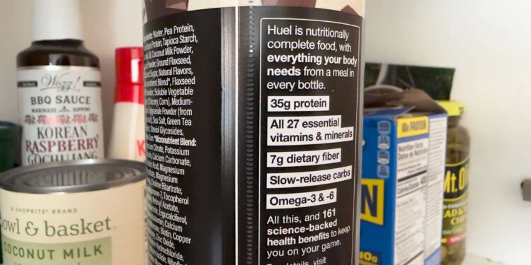 Close up of a Huel bottle’s nutritional label that says ‘Huel is nutritionally complete food with everything your body needs from a meal in every bottle.’ It then lists the macronutrients and says ‘All this, and 161 science-backed health benefits to keep you on your game.’