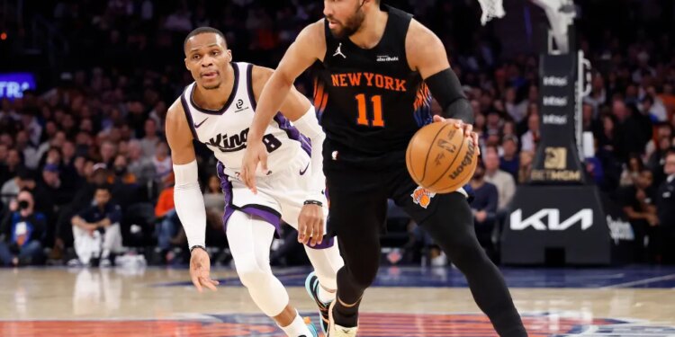 New York Knicks guard Jalen Brunson drives down court as Sacramento Kings guard Russell Westbrook gives chase.