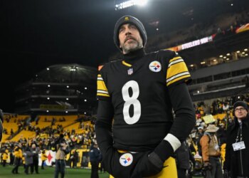 Pittsburgh Steelers quarterback Aaron Rodgers on the field after a game.