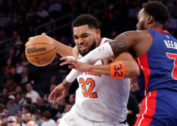 New York Knicks center Karl-Anthony Towns (32) drives to the basket as Detroit Pistons forward Paul Reed (7) defends.
