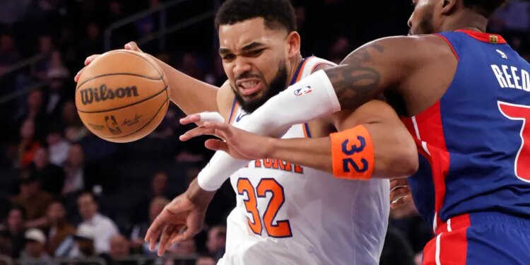 New York Knicks center Karl-Anthony Towns (32) drives to the basket as Detroit Pistons forward Paul Reed (7) defends.