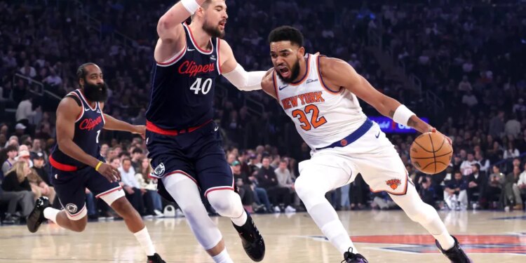 New York Knicks center Karl-Anthony Towns drives to the basket as LA Clippers center Ivica Zubac defends during the first quarter.