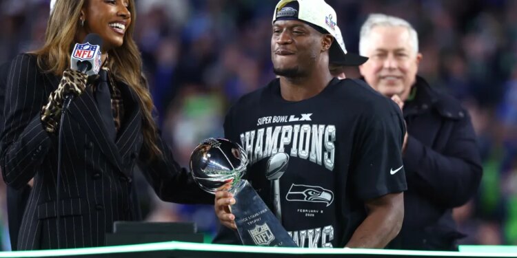 Seattle Seahawks running back Kenneth Walker III celebrates with the Vince Lombardi trophy after defeating the New England Patriots in Super Bowl LX.