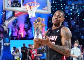 Miami forward Keshad Johnson holds Slam Dunk Contest trophy
