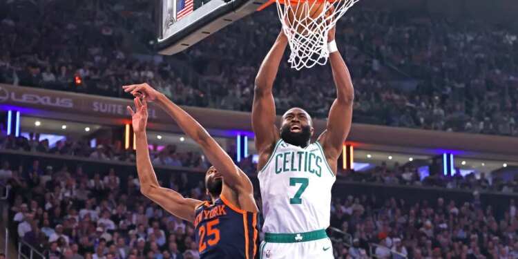 Boston Celtics guard Jaylen Brown #7 slams the ball during a game against the New York Knicks.