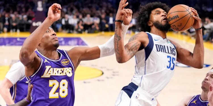 Dallas Mavericks forward Marvin Bagley III holding the ball away from Los Angeles Lakers forward Rui Hachimura.