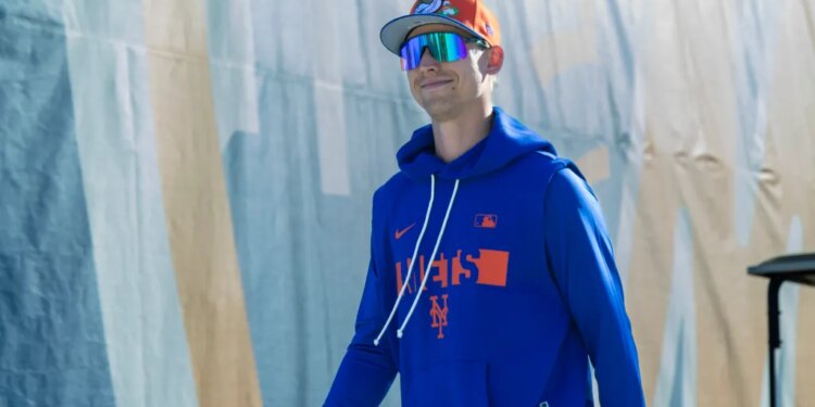 New York Mets pitcher Luke Weaver in a blue hoodie and orange cap.