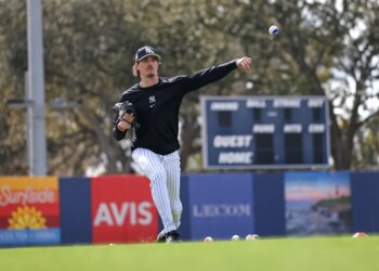 New York Yankees pitcher Max Fried #54 throws a ball with blue paint during a workout at Steinbrenner Field.