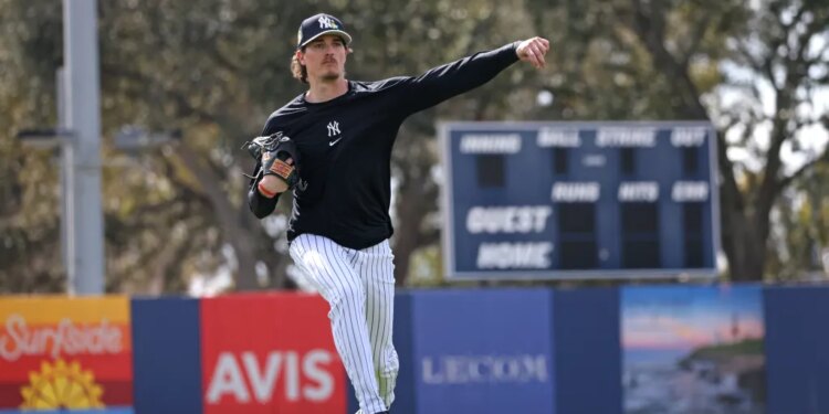 New York Yankees pitcher Max Fried #54 throws a ball with blue paint during a workout at Steinbrenner Field.