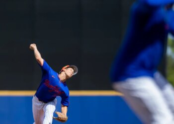 New York Mets pitcher Jonah Tong throws a baseball during spring training.