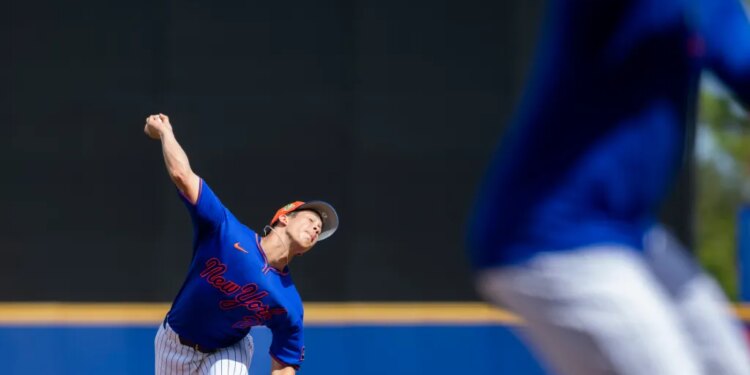 New York Mets pitcher Jonah Tong throws a baseball during spring training.