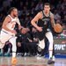 Brooklyn Nets forward Michael Porter Jr. dribbles down the court as New York Knicks guard Jalen Brunson gives chase.