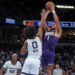 Phoenix Suns guard Devin Booker (1) shoots as Memphis Grizzlies forward Jaylen Wells (0) defends him.
