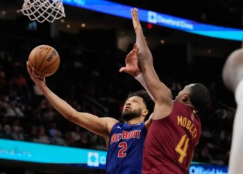 Detroit Pistons guard Cade Cunningham (2) shoots as Cleveland Cavaliers center Evan Mobley (4) defends.