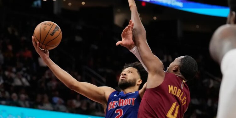 Detroit Pistons guard Cade Cunningham (2) shoots as Cleveland Cavaliers center Evan Mobley (4) defends.