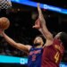 Detroit Pistons guard Cade Cunningham (2) shoots as Cleveland Cavaliers center Evan Mobley (4) defends.