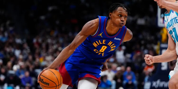 Denver Nuggets guard Peyton Watson (8) drives against Charlotte Hornets forward Tidjane Salaun (31) in the second half at Ball Arena.