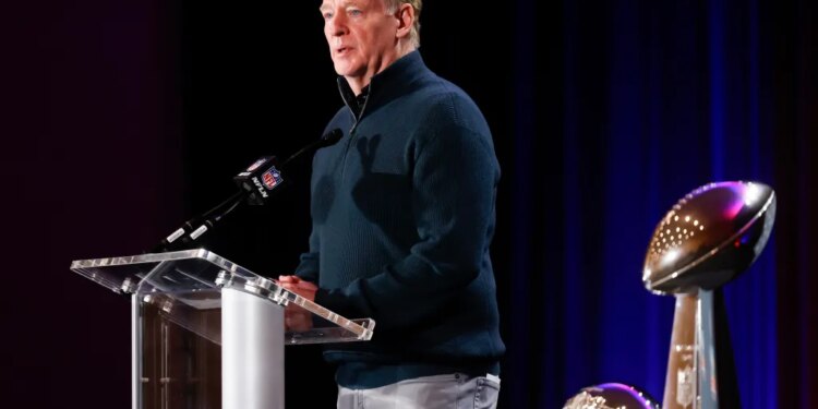 NFL Commissioner Roger Goodell speaks at a news conference next to the Vince Lombardi Trophy.