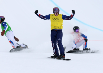 Nathan Pare (c.) finished first in his snowboard cross heat before being disqualified on Feb. 12, 2026.