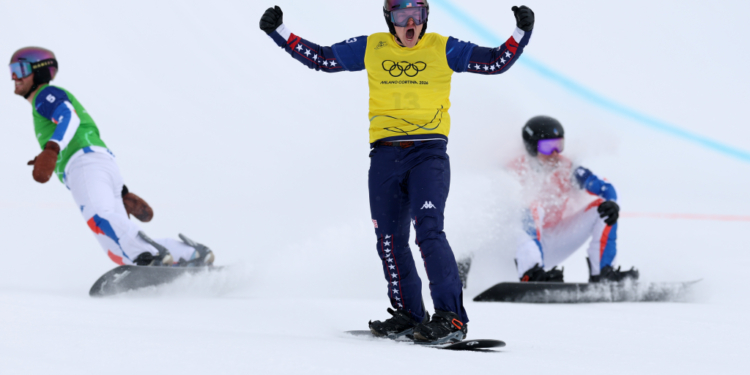 Nathan Pare (c.) finished first in his snowboard cross heat before being disqualified on Feb. 12, 2026.