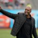Barry Bonds in a black jacket waving with a smile.
