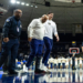 Notre Dame head coach Micah Shrewsberry is helped off the court while wearing a boot.