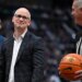 UConn head coach Dan Hurley smiles at official Brian O'Connell during an NCAA college basketball game.