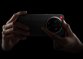Xiaomi 17 Ultra Leica Edition with a hand ready to twist the manual camera zoom