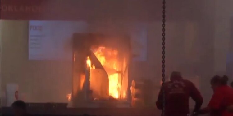 A popcorn machine ablaze during a Georgia-Oklahoma men's basketball game, with game stats shown on the left.