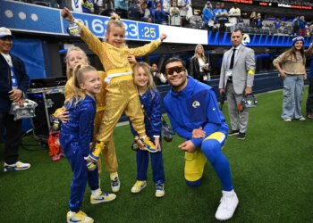 Los Angeles Rams wide receiver Puka Nacua (12) poses for a picture with quarterback Matthew Stafford’s daughters.